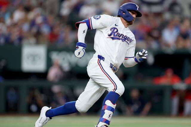 Texas Rangers outfielder Brandon Nimmo sprints around the bases to reach third during their home opener against the Cincinnati Reds on Friday, April 3, 2026.